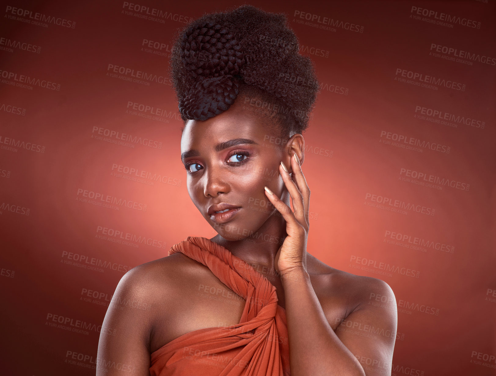 Buy stock photo Confident, black woman and makeup with hands in studio for beauty or glamour by red background. Pride, African and female person and cosmetic with foundation for glow or shine as model in Nigeria