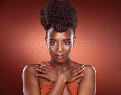 Buy stock photo Cropped portrait of an attractive young woman posing in studio against a red background