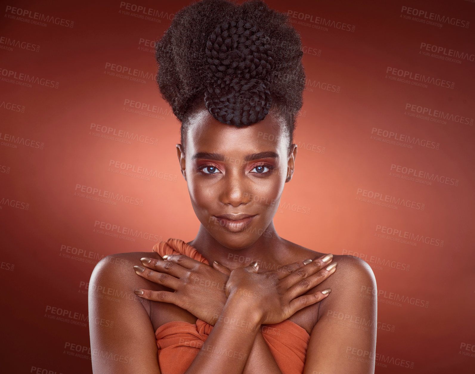 Buy stock photo Cropped portrait of an attractive young woman posing in studio against a red background