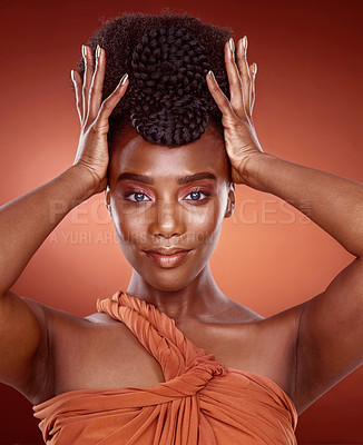 Buy stock photo Cropped portrait of an attractive young woman posing in studio against a red background