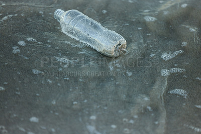 Buy stock photo Plastic bottle, rubbish or recycling on beach pollution for clean up, waste management or environmental awareness. Garbage, trash or litter on sand for conservation, climate change or global warming