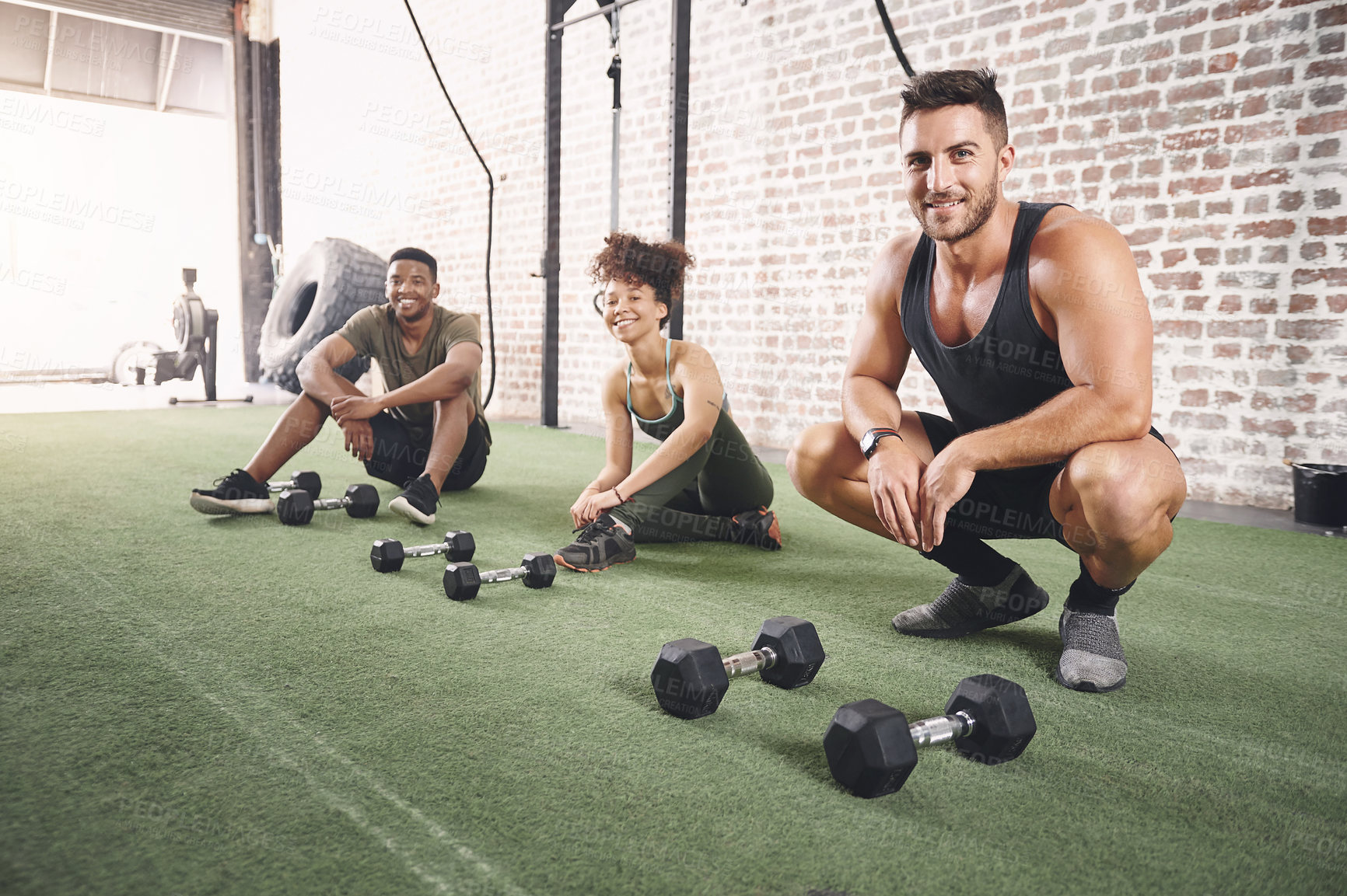 Buy stock photo Shot of a fitness group resting after working out with dumbbells