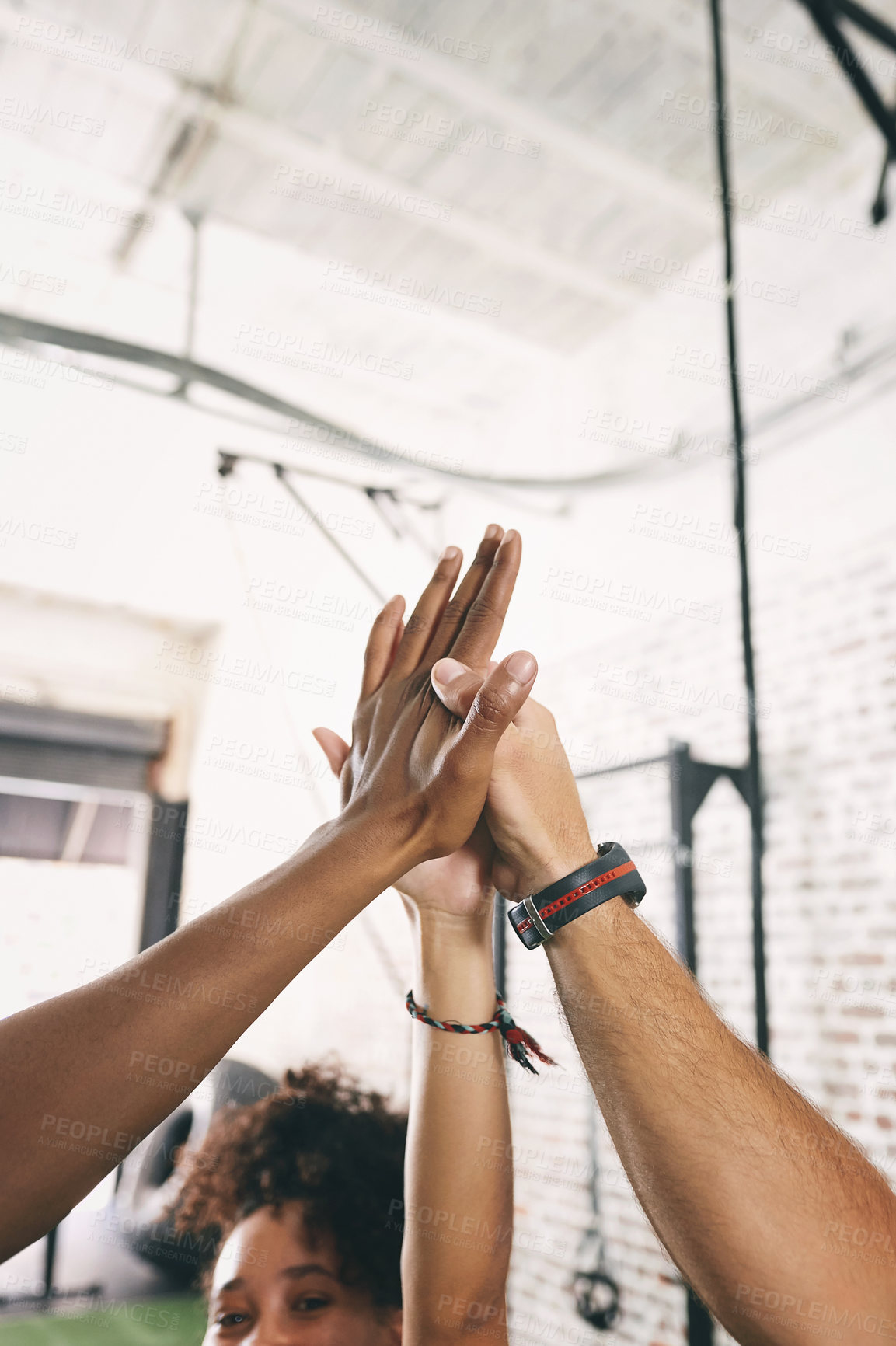 Buy stock photo Shot of three sporty young people giving each other a high five