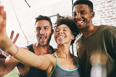 Buy stock photo Cropped shot of three sporty young people taking a selfie at the gym