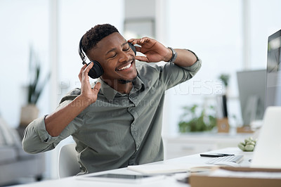 Buy stock photo Shot of a young man on a call at work in a office