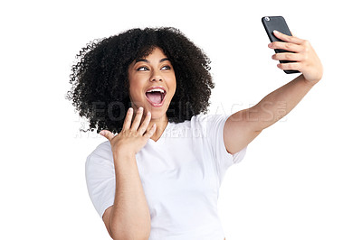 Buy stock photo Studio shot of an attractive young woman using a smartphone to take selfies against a white background