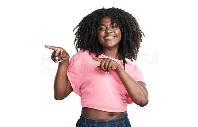 Buy stock photo Studio shot of an attractive young woman pointing at copy space against a white background