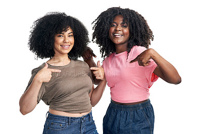 Buy stock photo Studio shot of two young women pointing at their t shirts against a white background
