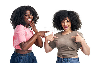 Buy stock photo Studio shot of two young women pointing at their t shirts against a white background