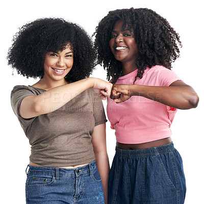 Buy stock photo Studio shot of two young women bumping fists against a white background