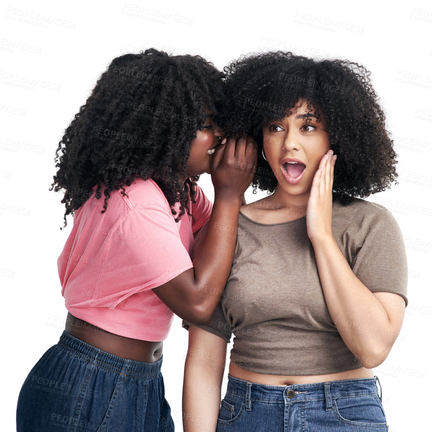 Buy stock photo Studio shot of a young woman whispering in her friend’s ear against a white background