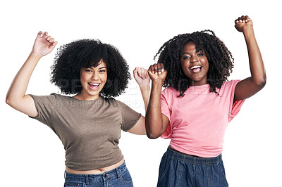 Buy stock photo Studio shot of two young women cheering against a white background