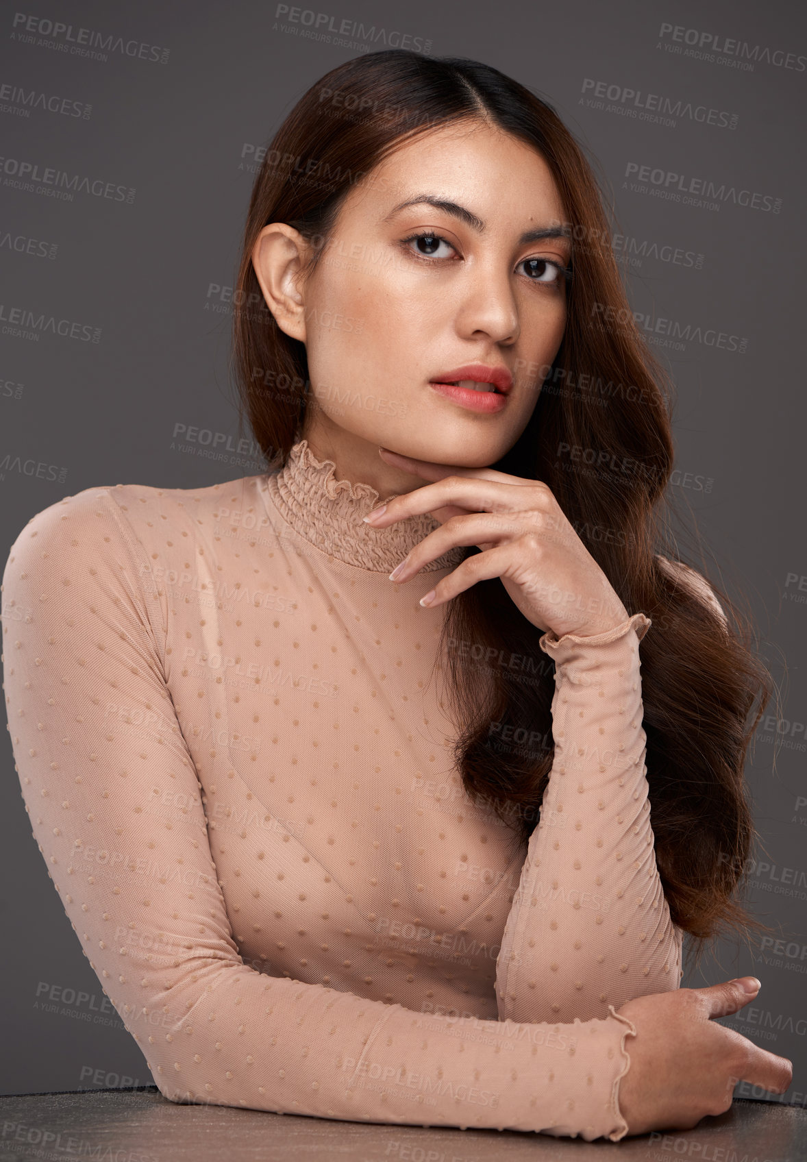 Buy stock photo Cropped portrait of an attractive young woman posing in studio against a grey background