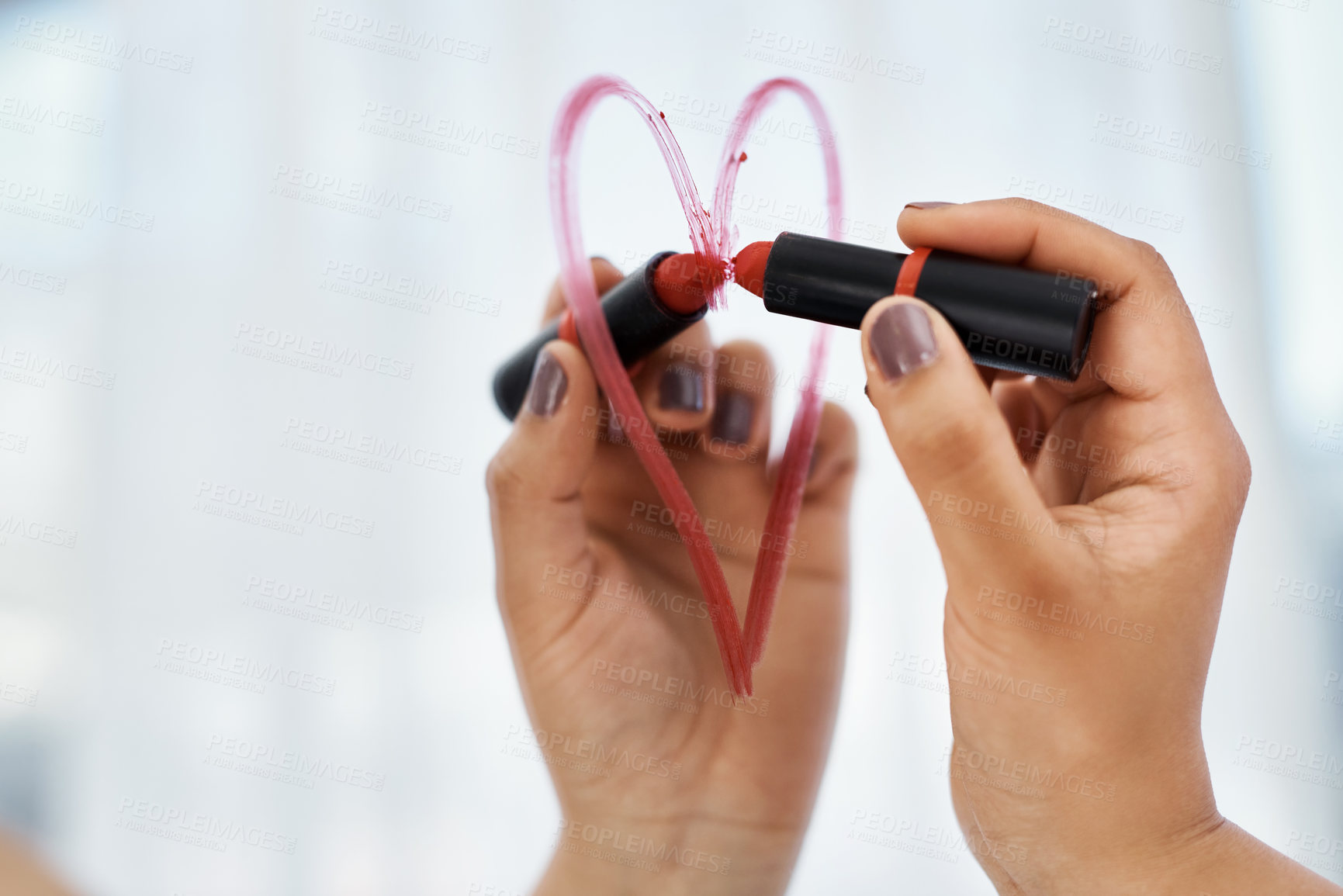 Buy stock photo Cropped shot  of a woman drawing a heart shape with lipstick on the bathroom mirror at home