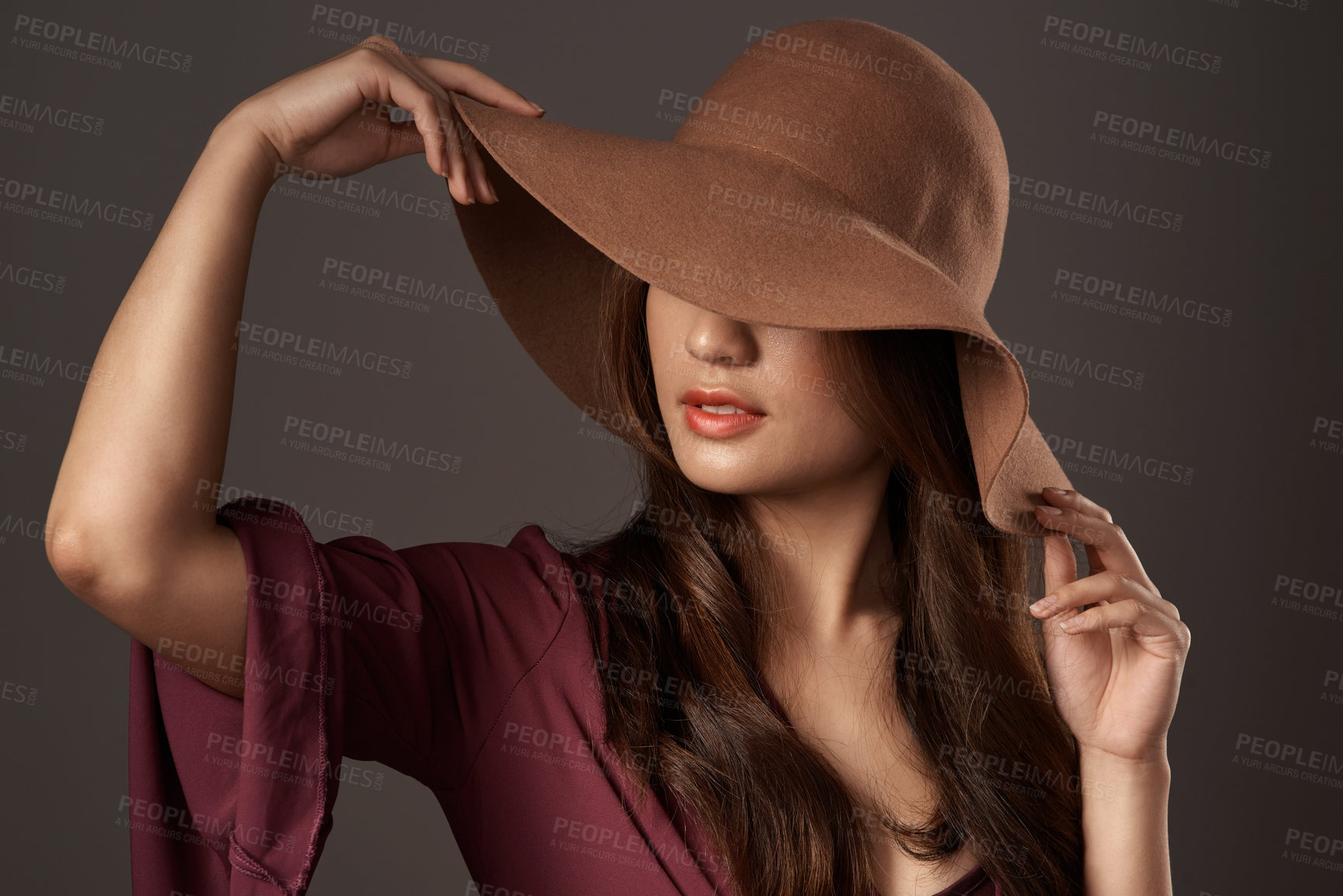 Buy stock photo Cropped shot of an attractive young woman posing in studio against a grey background