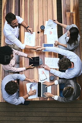 Buy stock photo High angle shot of a team of businesspeople having a meeting outside