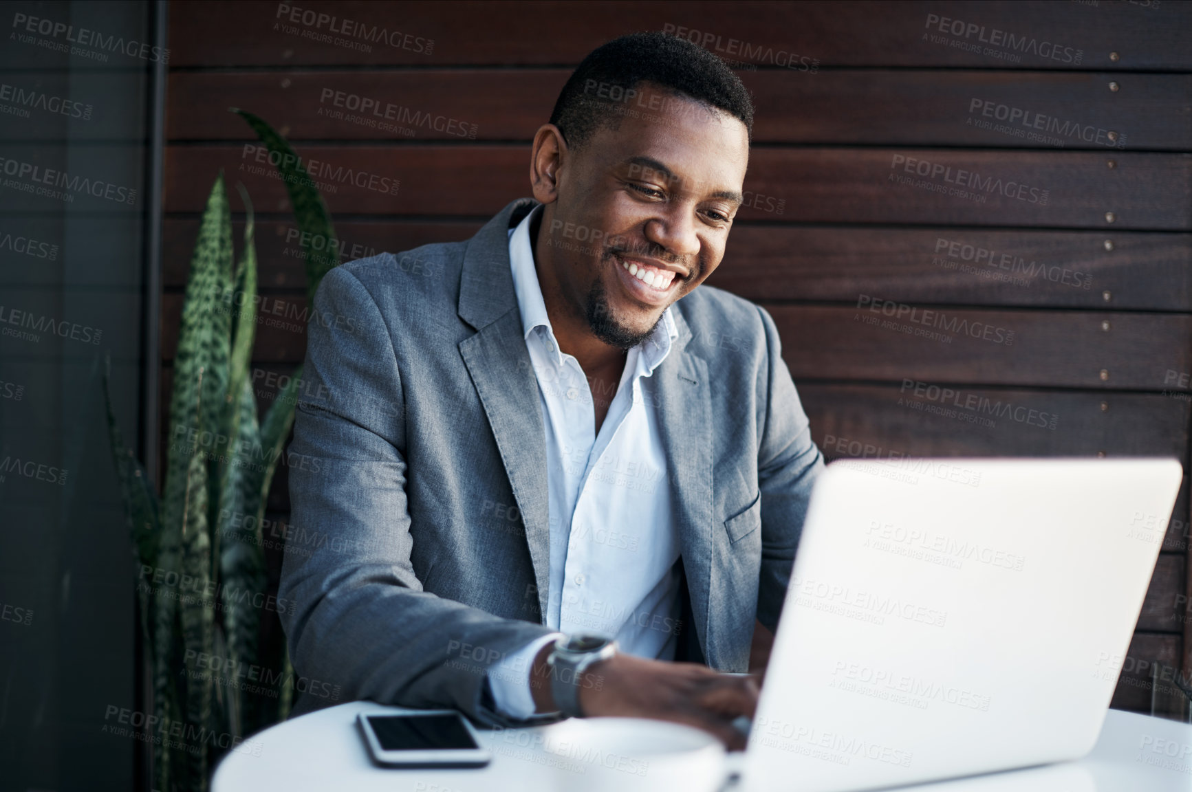 Buy stock photo Typing, laptop and businessman at office for communication with client for feedback on investment growth. Finance, computer and African underwriter with report for online financial risk evaluation.