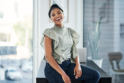 Buy stock photo Shot of an attractive young businesswoman sitting alone in her office during the day