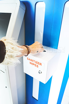 Buy stock photo Cropped shot of a person using the sanitiser wipes at the airport