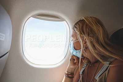 Buy stock photo Shot of a young woman looking out the window in the aeroplane