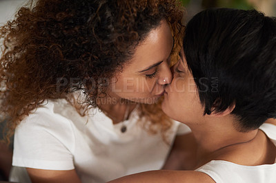 Buy stock photo Cropped shot of an affectionate couple sharing a kiss at home