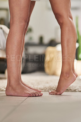 Buy stock photo Low angle shot of a couple's feet while standing together at home