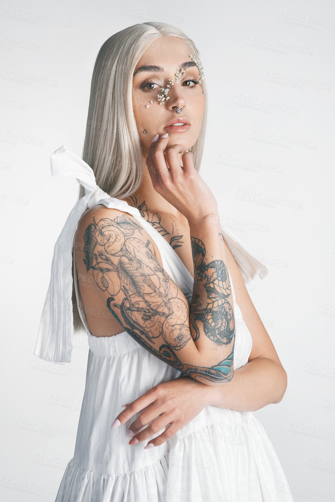 Buy stock photo Cropped portrait of an attractive young woman posing against a grey background in studio