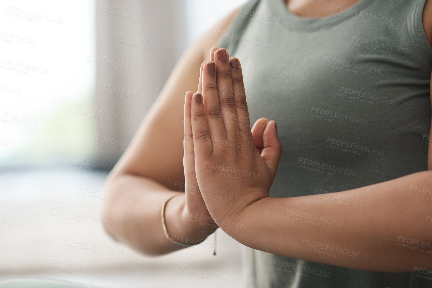 Buy stock photo Closeup shot of an unrecognisable woman meditating at home