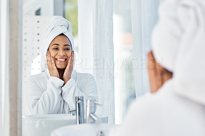 Buy stock photo Shot of a young woman going through her beauty routine at home