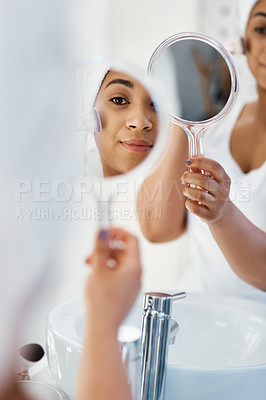 Buy stock photo Shot of a young woman going through her beauty routine at home