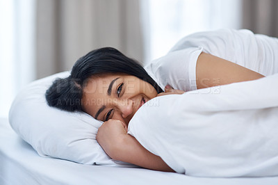 Buy stock photo Shot of a young woman in bed at home