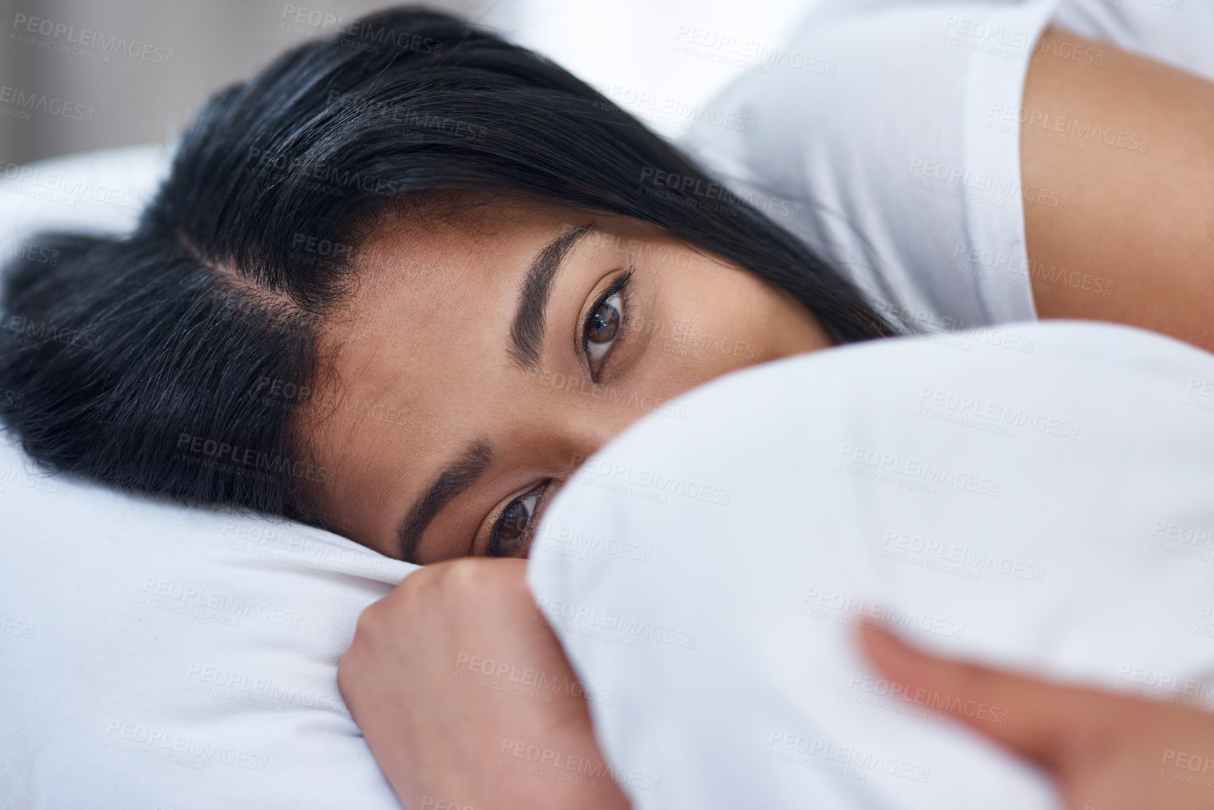 Buy stock photo Shot of a young woman in bed at home