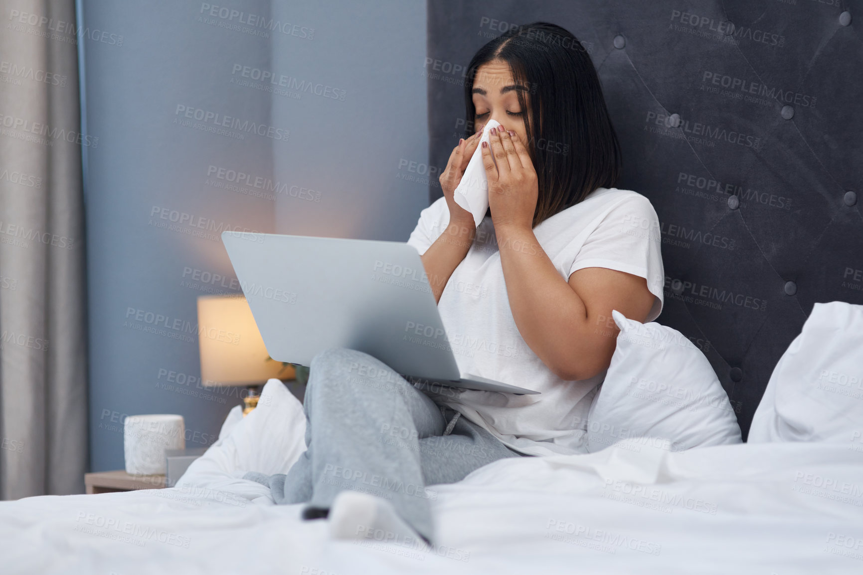 Buy stock photo Shot of a young woman feeling sick in bed at home