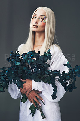 Buy stock photo Cropped portrait of an attractive young woman posing against a grey background in studio