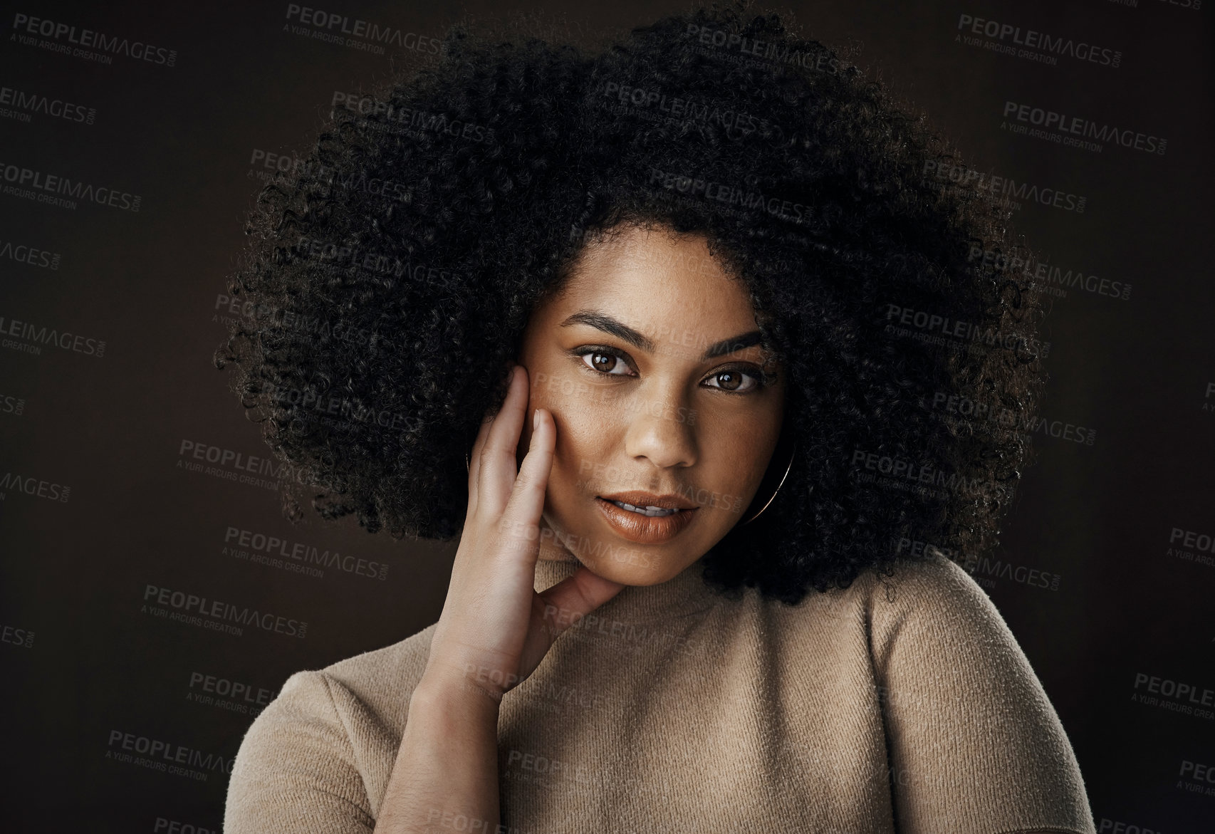 Buy stock photo Cropped portrait of an attractive young woman posing in studio against a dark background