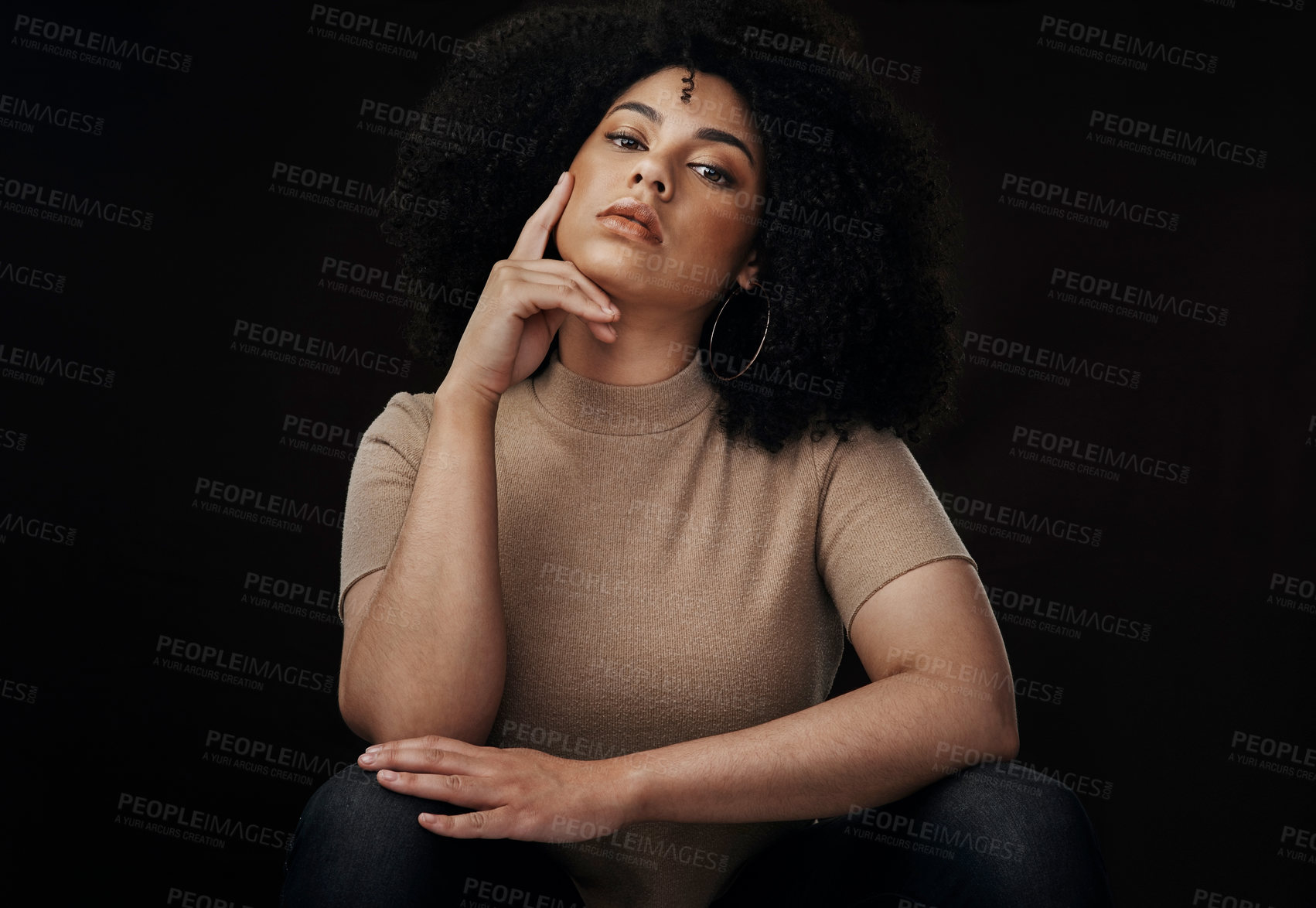 Buy stock photo Cropped portrait of an attractive young woman posing in studio against a dark background