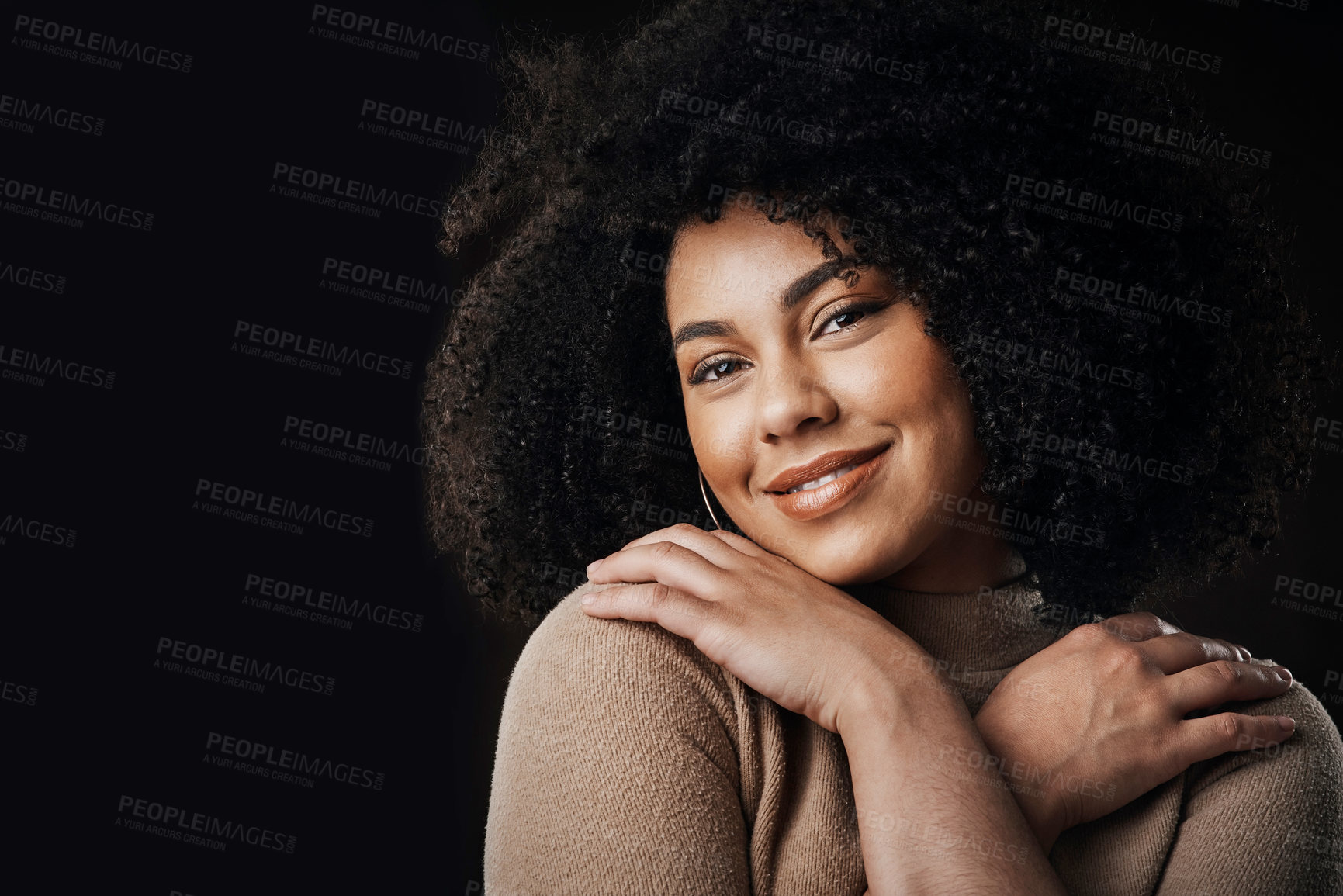 Buy stock photo Cropped portrait of an attractive young woman posing in studio against a dark background