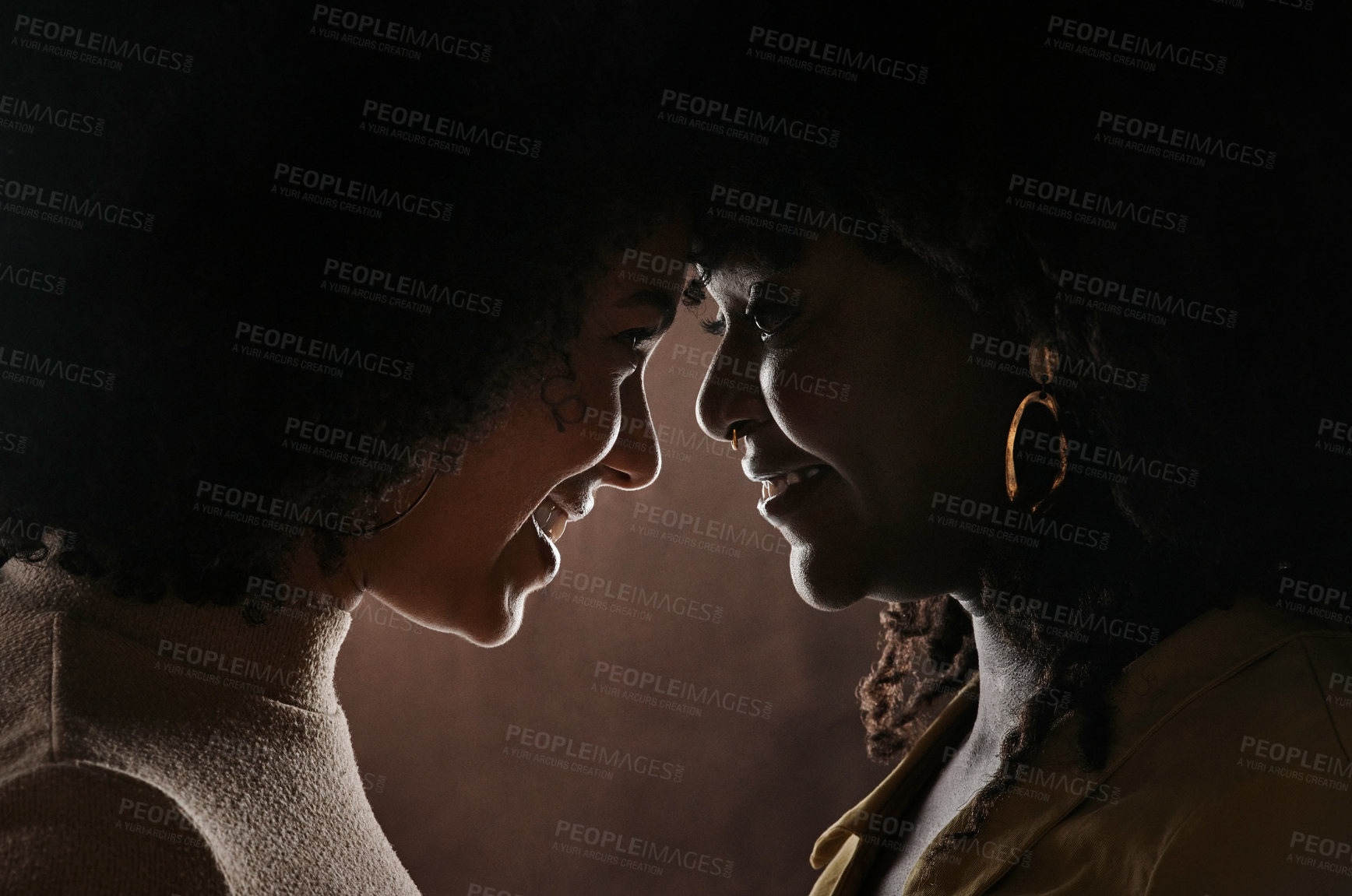 Buy stock photo Cropped shot of a beautiful young female couple posing in studio against a dark background