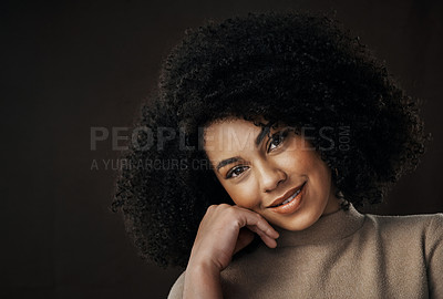 Buy stock photo Cropped portrait of an attractive young woman posing in studio against a dark background