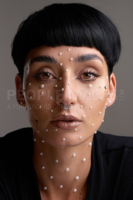 Buy stock photo Studio portrait of a beautiful young woman with pearls on her face posing against a grey background