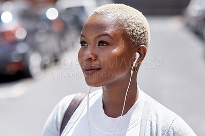 Buy stock photo Music, vision and travel with a black woman in the city, thinking about future opportunity during the day. Mindset, idea and tourism with a young female traveler streaming audio in an urban town