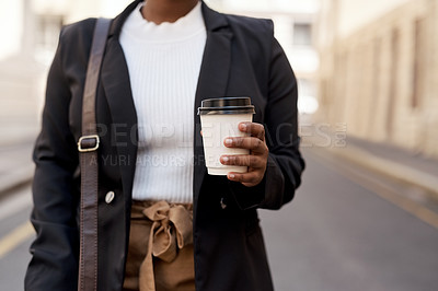 Buy stock photo Closeup shot of an unrecognisable businesswoman holding a coffee cup while out in the city
