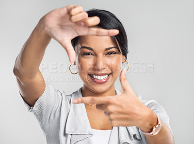 Buy stock photo Studio shot of a confident young businesswoman making a frame with her fingers against a grey background