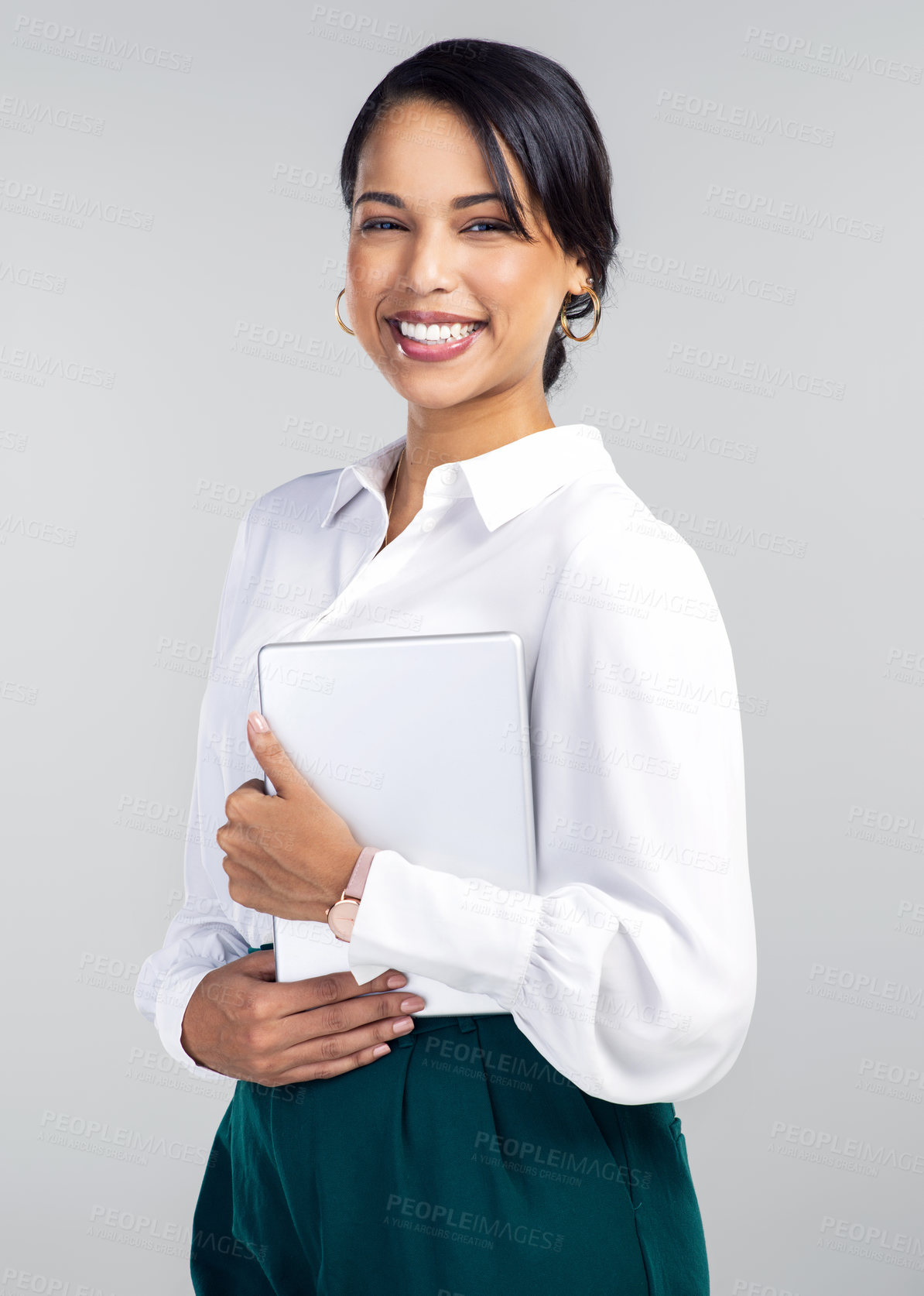 Buy stock photo Studio shot of a young businesswoman using a digital tablet against a grey background