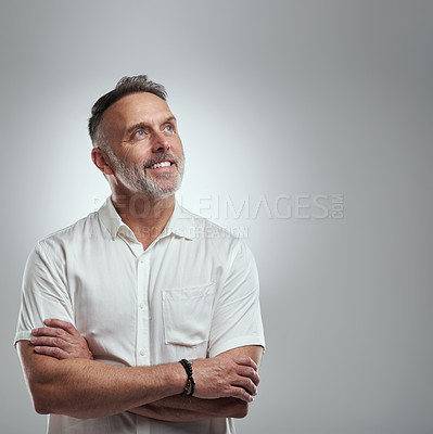 Buy stock photo Studio shot of a mature man looking thoughtful against a grey background