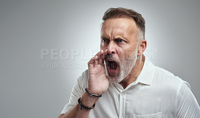 Buy stock photo Studio shot of a mature man yelling against a grey background