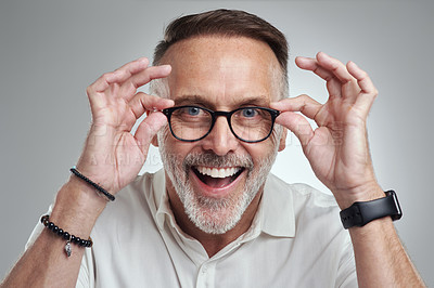 Buy stock photo Studio portrait of a mature man wearing spectacles against a grey background