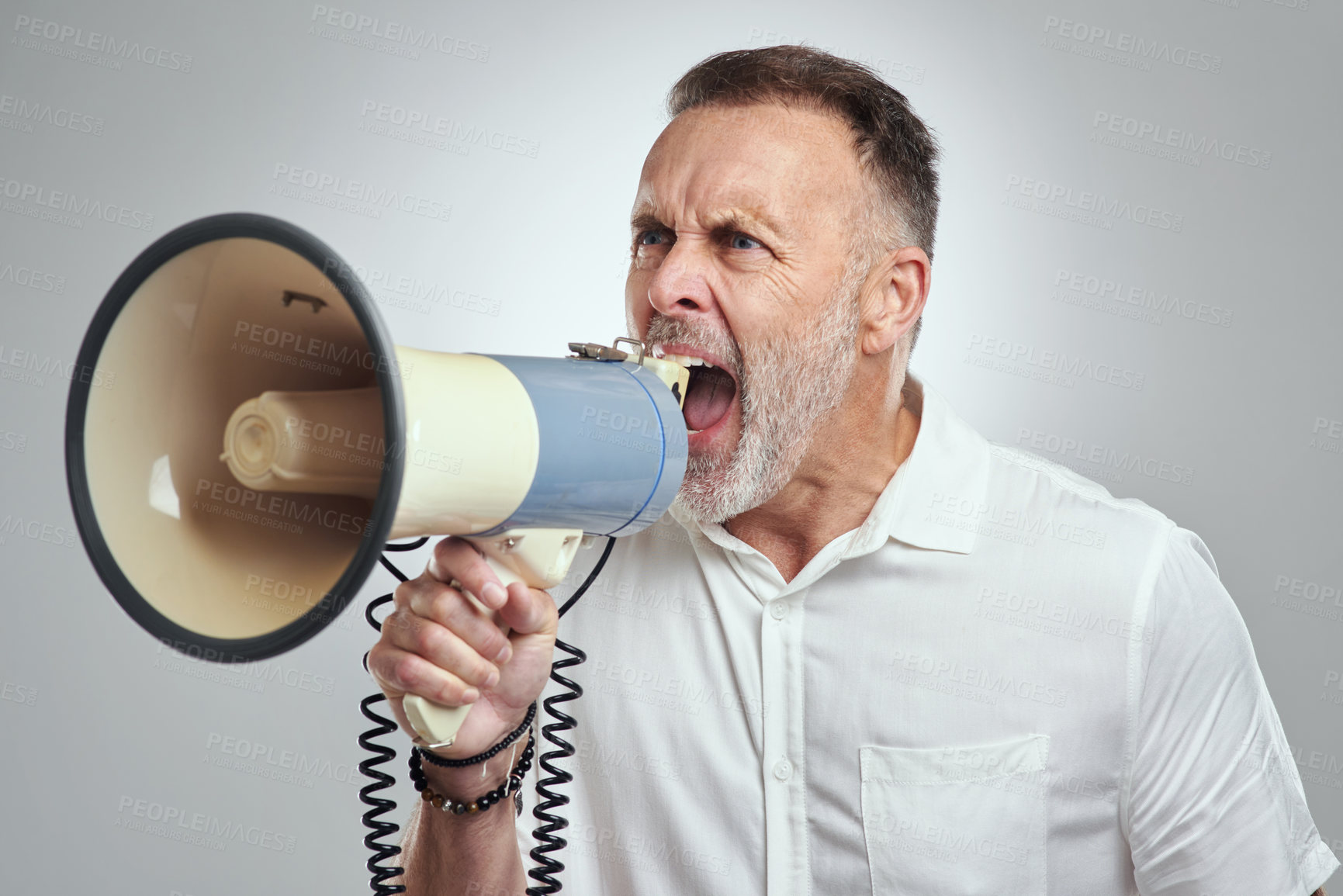 Buy stock photo Studio shot of a mature man using a megaphone against a grey background