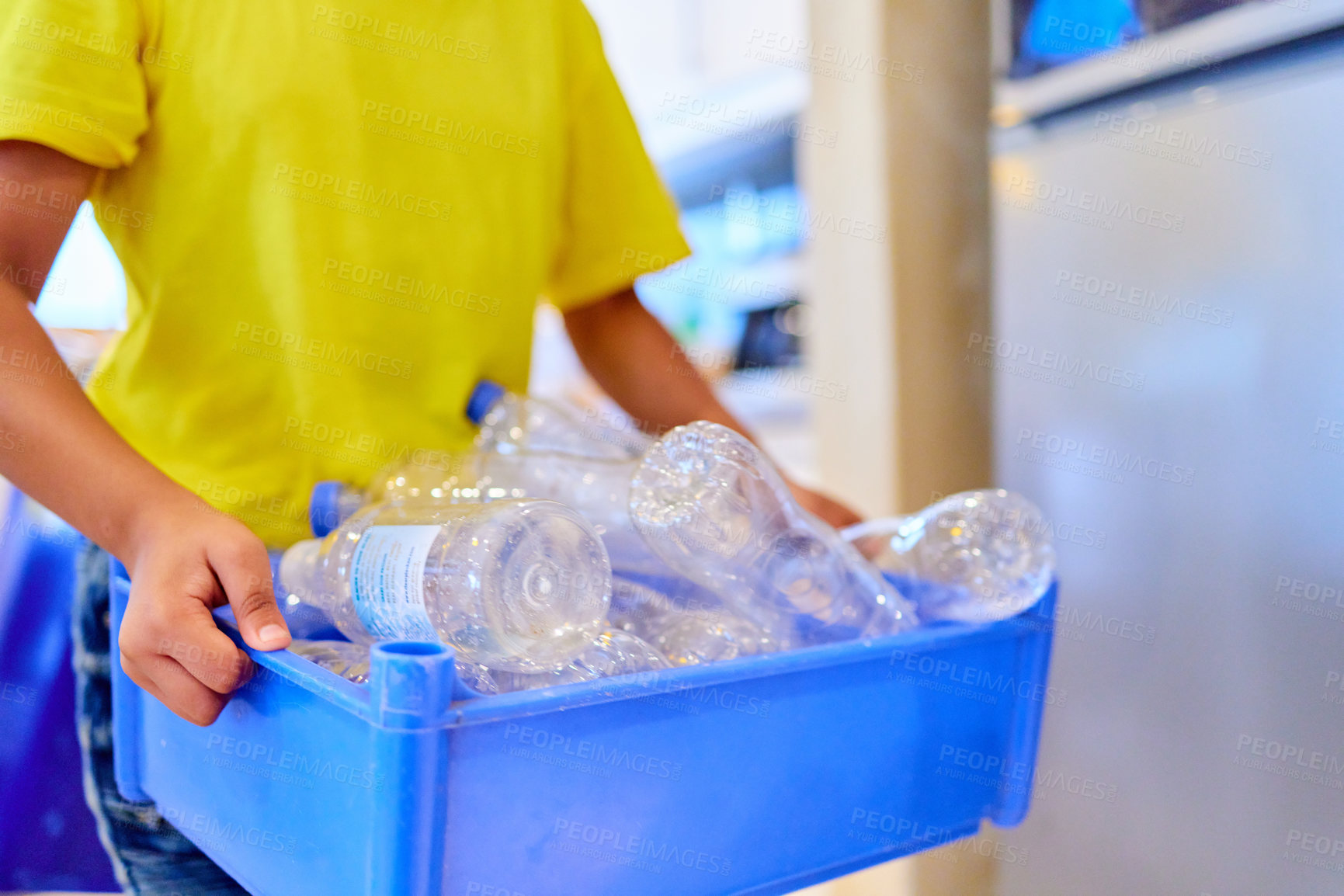 Buy stock photo Cropped shot of a boy carrying a container with bottles at home