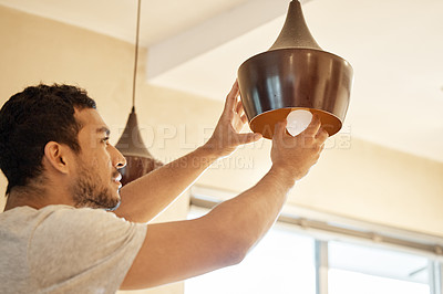 Buy stock photo Repair, home and man change light bulb for maintenance, installation or building or property renovation. Handyman, ceiling lightbulb and male person with energy saving globe for illumination at house